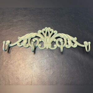 decorative cast iron wall hook with a shabby chic or antique teal finish.